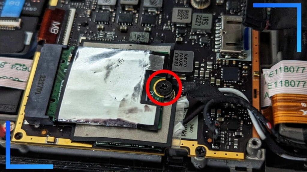 Close-up photo of the Steam Deck's original SSD with a red circle above the screw.