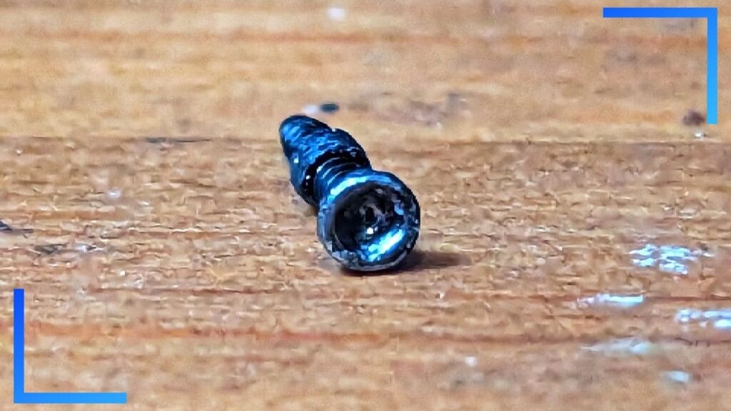 Photo of a Steam Deck screw with the thread worn off.