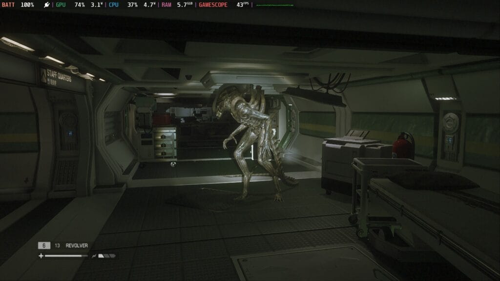 Screenshot from Alien Isolation showing a dark grey and black corridor. A beam of light cuts through the middle to reveal the Xenomorph prowling.