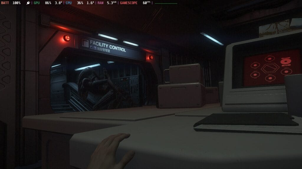 Screenshot from Alien Isolation from the perspective of someone hiding a white desk that appears grey due to the low lighting. In the arched doorway, an Alien can see walking away.