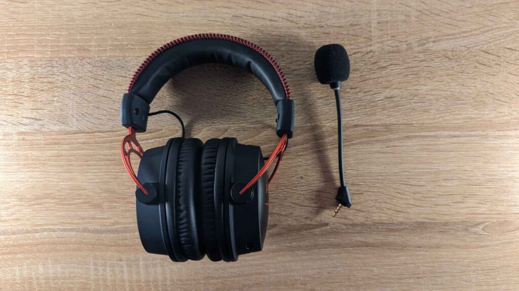 Photo of the HyperX Cloud Alpha Wireless from above. In this photo the black mic is unplugged and to the right of the headset.