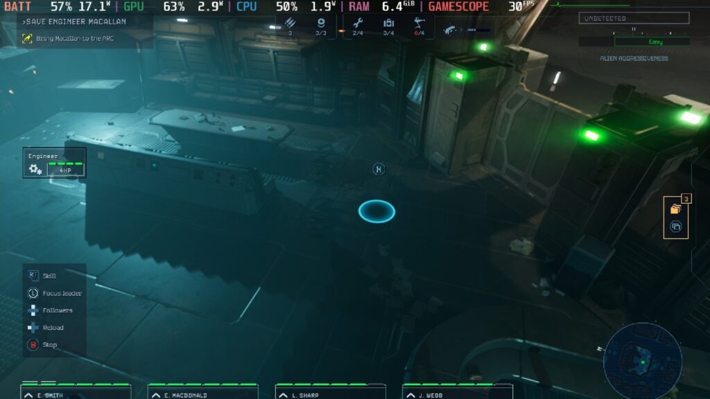 Screenshot from Aliens: Dark Descent showing a bird's eye view of a room in a blue-green hue.