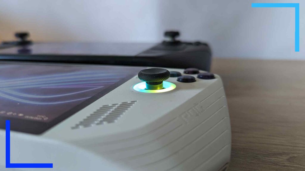 Close-up photo of the white ASUS ROG Ally's right thumbstick and ring light lit up in shades of yellow and green.