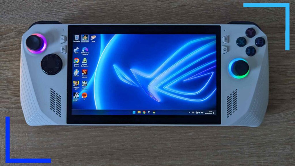 Close up photo of the white ASUS ROG Ally handheld. The Windows 11 blue desktop with icons can be seen on the main screen.