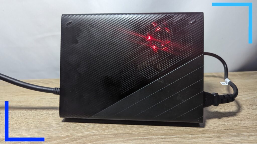 Front on photo of the XG Mobile - a black box with a red light shining through.