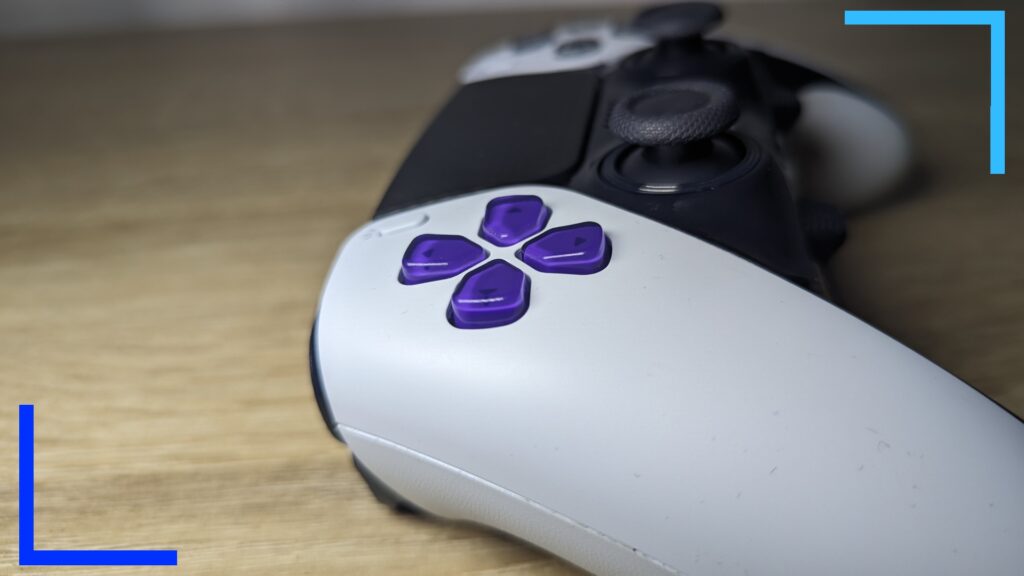 Close up photo of my MegaModz controller in white with custom purple directional buttons.