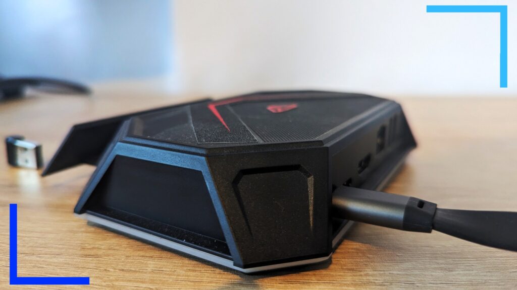 Close up photo of the right side of the black JSAUX RGB dock with a black USB-C cable coming from the back.