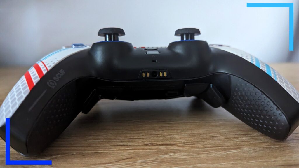 Close up photo of the Scuf controller from the bottom showing the black underside with the black thumbsticks at the top.