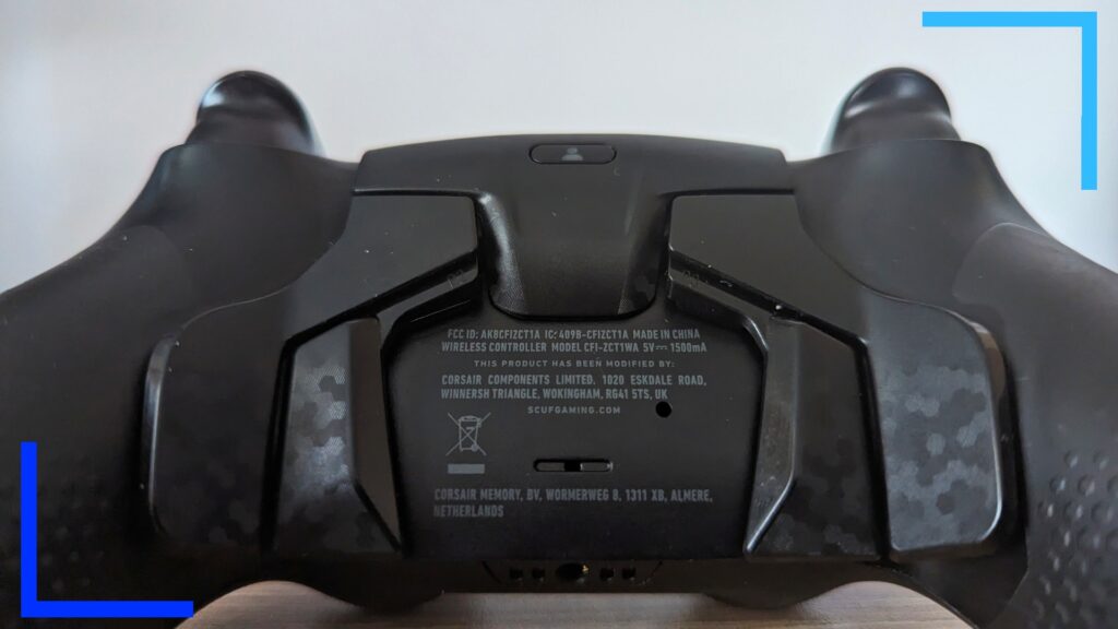 Close up photo of the Scuf controller showing the black back of the controller with four black back paddles with gray camo on them.