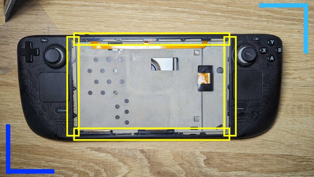 The Steam Deck with the screen removed and yellow boxes over where the new adhesive goes.