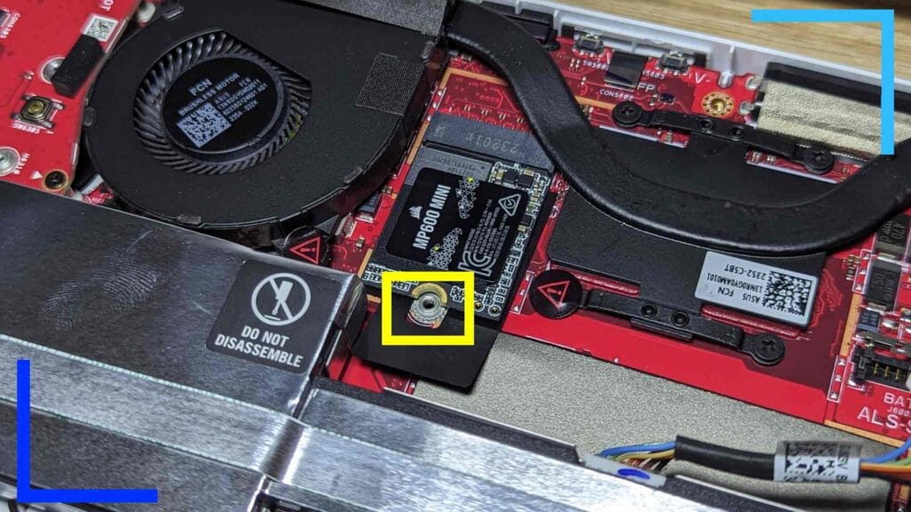 Close up photo of the new SSD installed in the ASUS ROG Ally. A yellow rectangle shows where to insert the screw.