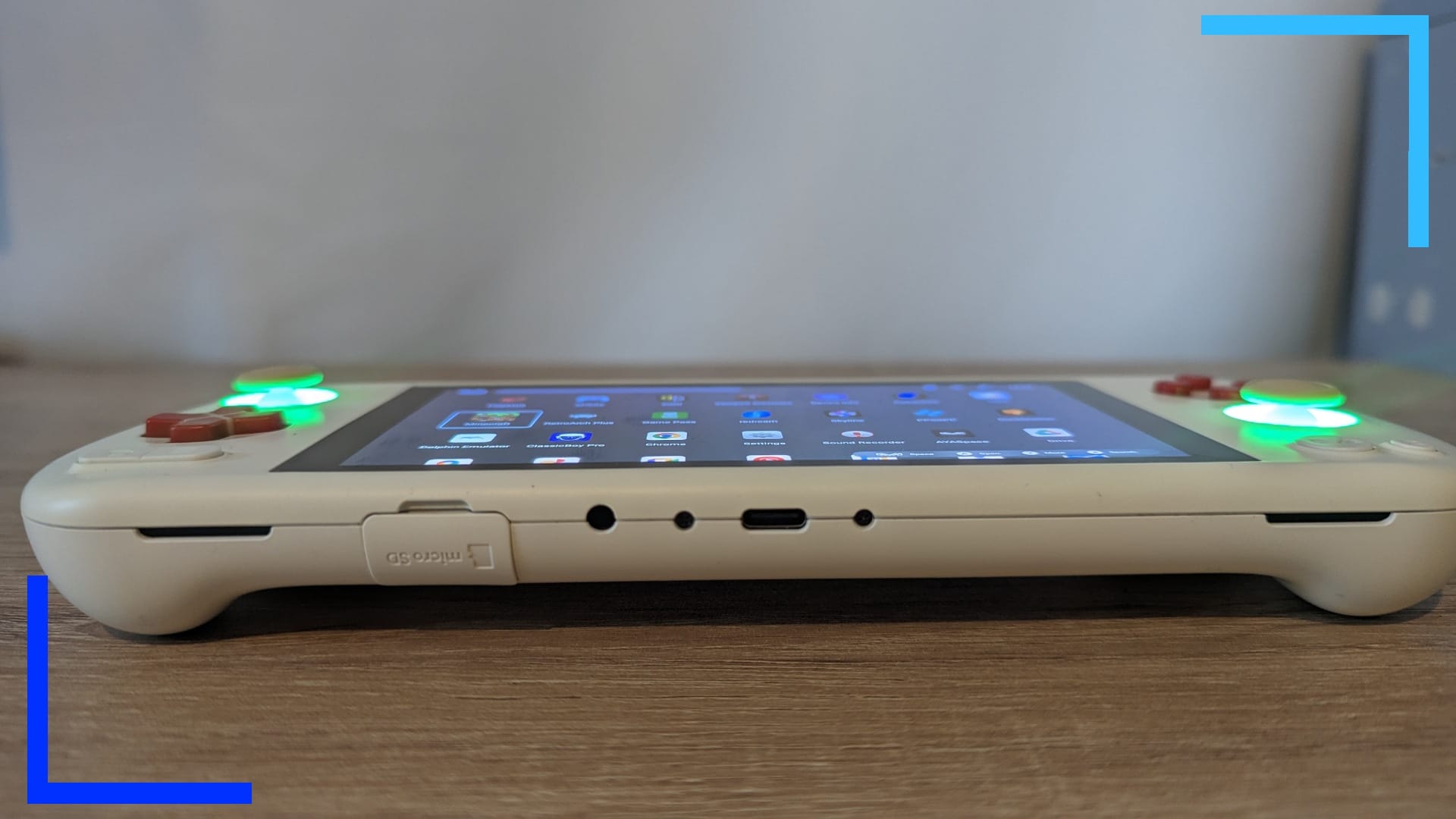 Close-up photo of the bottom of the white AYANEO Pocket Air showing the micro SD slot, USB-C, and headphones port.