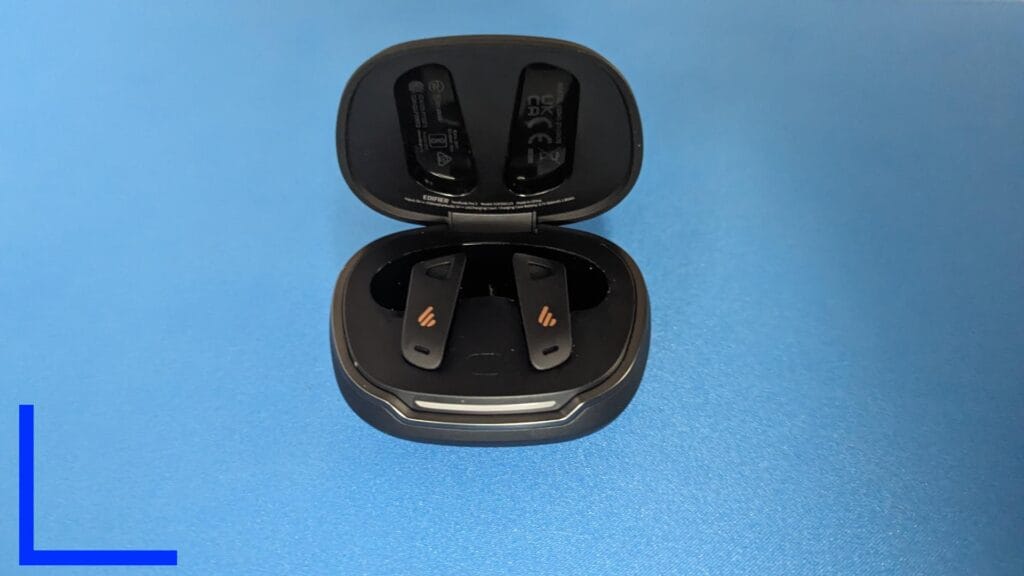 Photo of the black NeoBuds Pro 2 from above, in the black charging case.