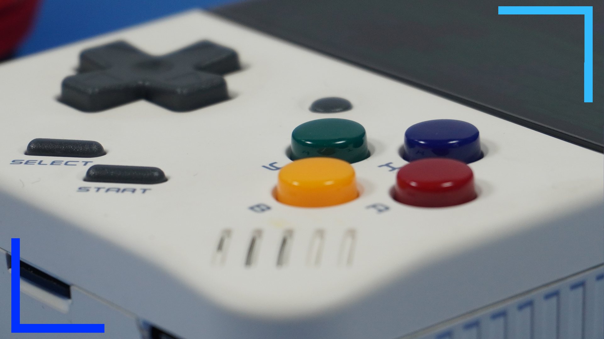 Close up photo of the four colored face buttons in green, blue, yellow, and red.