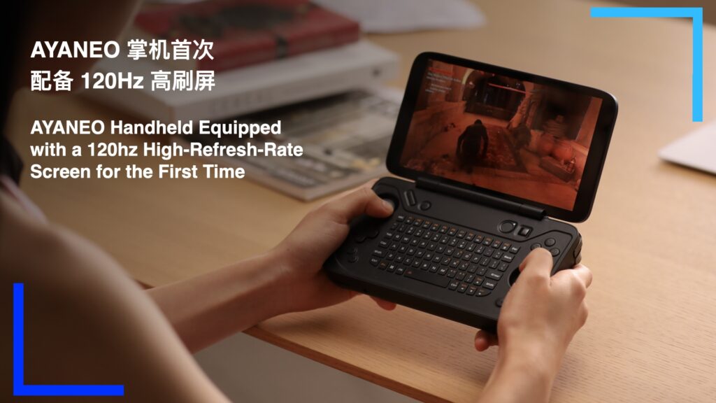 A person, likely a woman, playing on the black AYANEO Flip KB on an oak table.