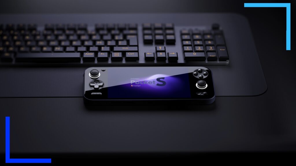 The black AYANEO Pocket S in front of a black full sized keyboard.