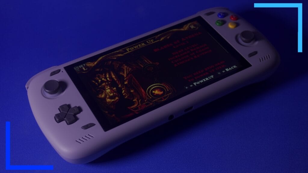 The gray AYN Odin2 with God of Wars' pause menu on the main screen.