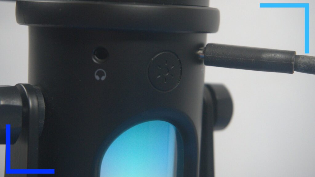 Close up showing the USB in, headphone jack, and the RGB control button.