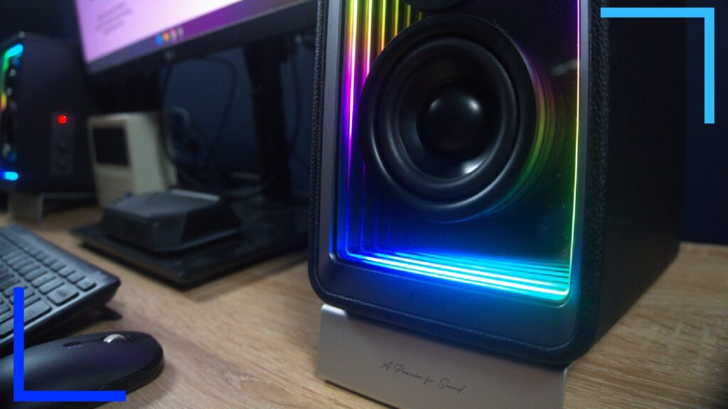 Close up photo showing the neon lights in blue, pink, and yellow on the inside of the QR65 speakers.