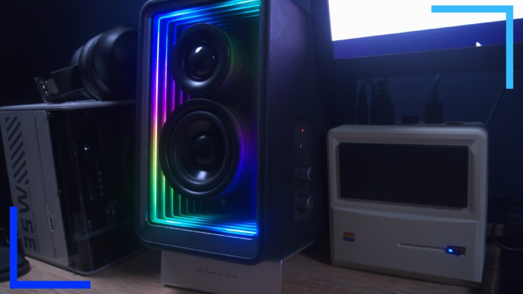 Close up shot of the QR65 left speaker next to a white AYANEO Mini PC.