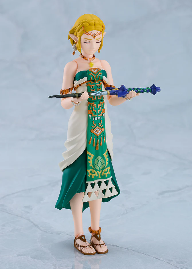 Zelda, eyes closed, holds the broken Master Sword.