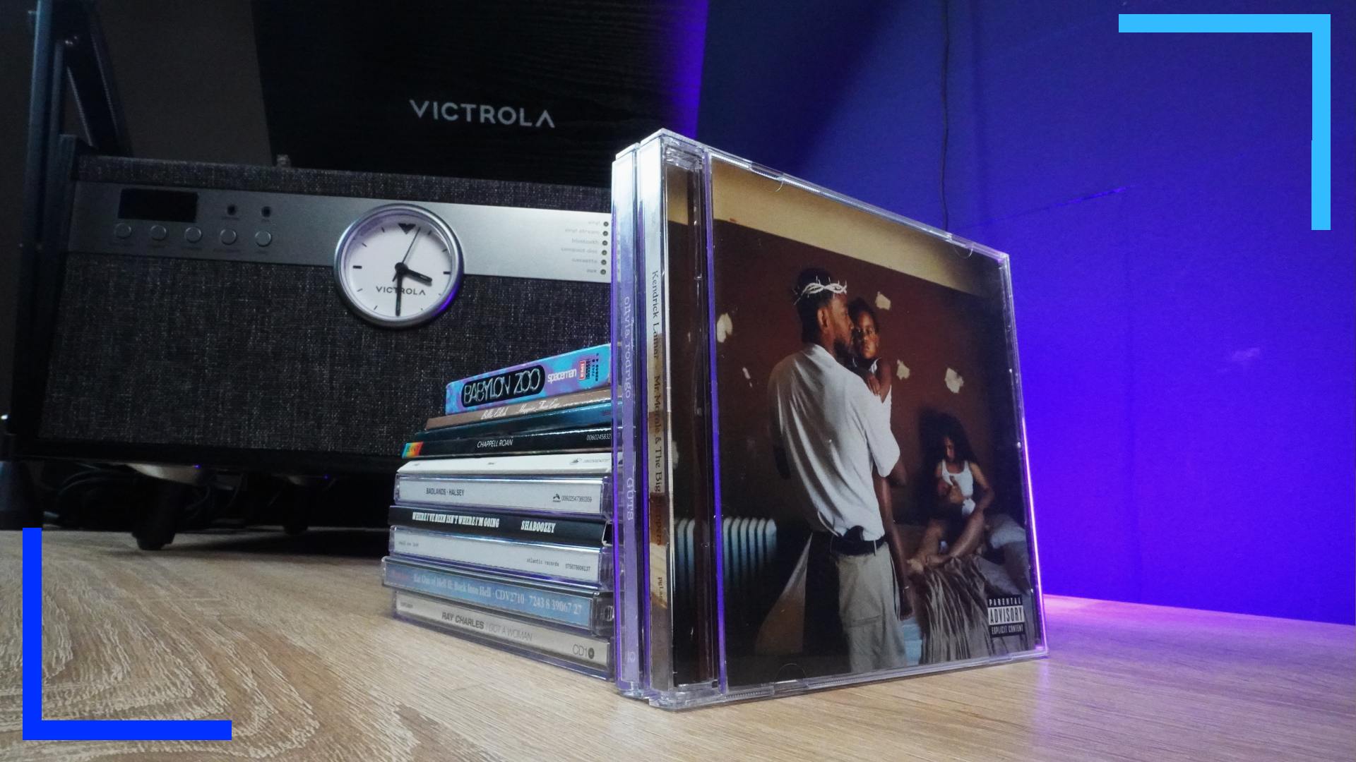 Artistic photo of a CD and cassette collection in front of the Victrola Century. The main visibile CD is Kendrick Lamar's Mr Morale.