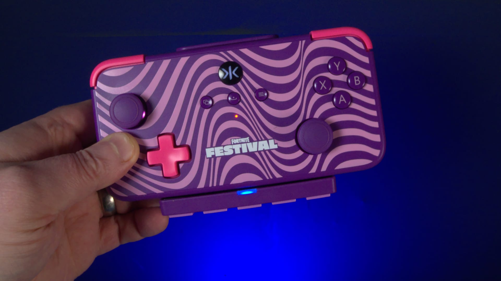 Wesley Copeland's hand holding the Purple Wave controller.