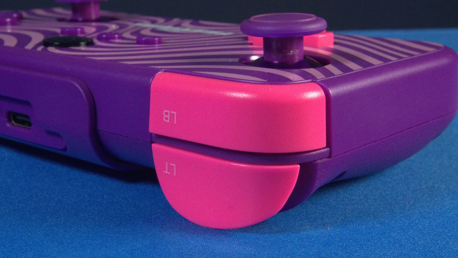 Close up photo of the left bumper and trigger in bright pink.