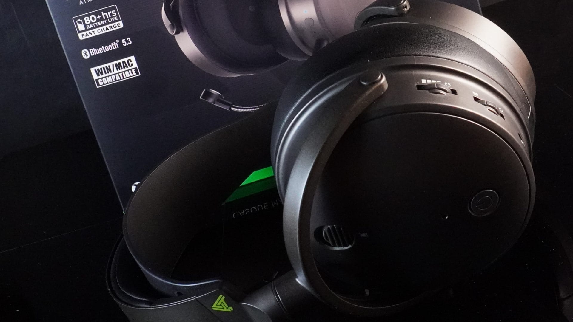 Angled photo showing the Maxwell headphones in front of the main box packaging.
