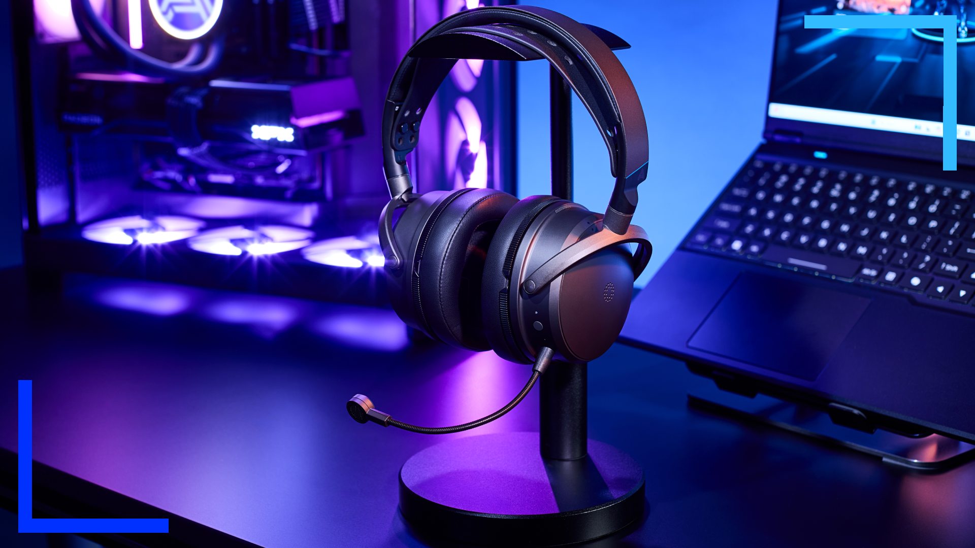 The Maxwell 2 on a headset stand in front of a laptop and gaming PC.