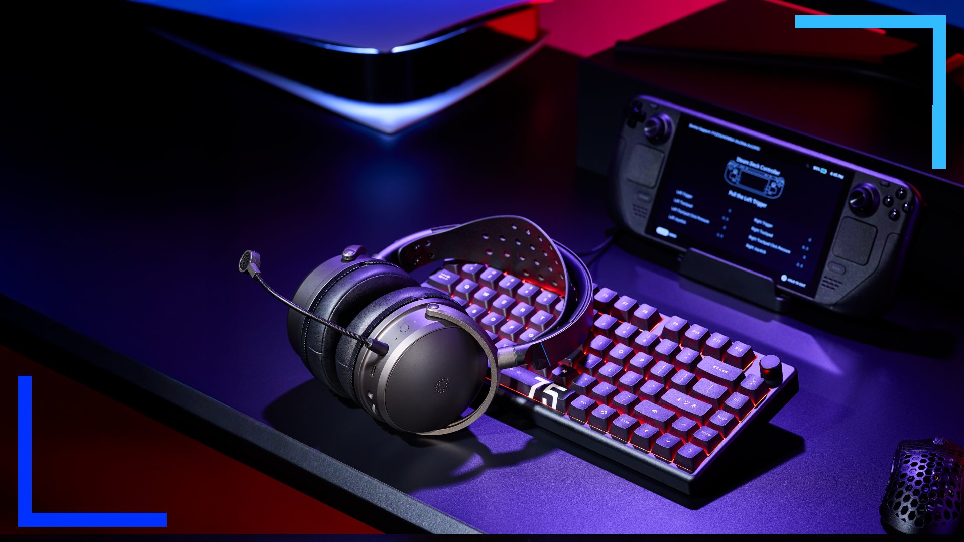 A black Audeze Maxwell 2 on a dark desk in front of a Steam Deck.